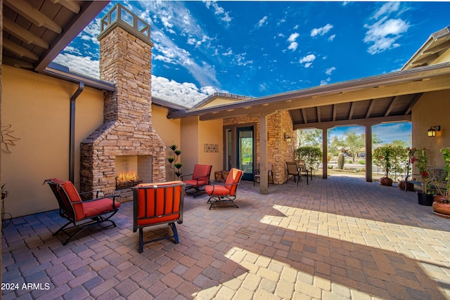 view of patio / terrace with an outdoor stone fireplace