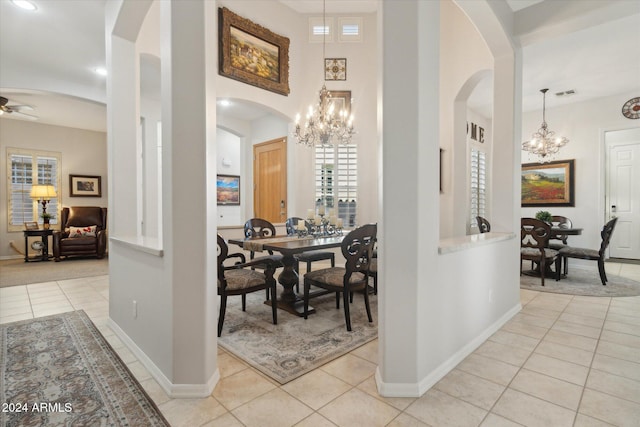 interior space featuring ceiling fan with notable chandelier and light tile patterned flooring