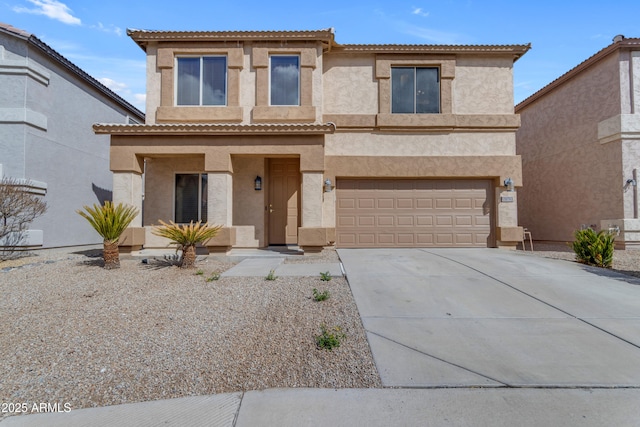 view of front of house with a garage, driveway, a tiled roof, and stucco siding