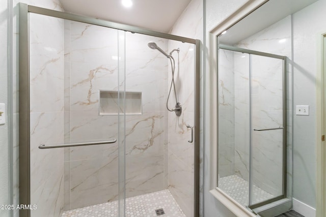 bathroom with a marble finish shower