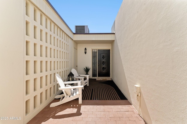 doorway to property featuring stucco siding