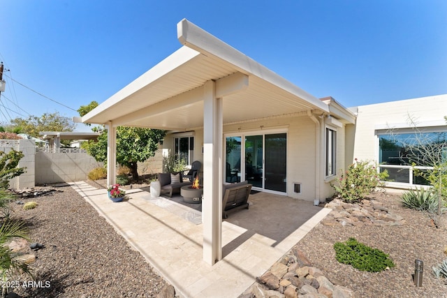 back of house featuring a patio area, outdoor lounge area, and fence