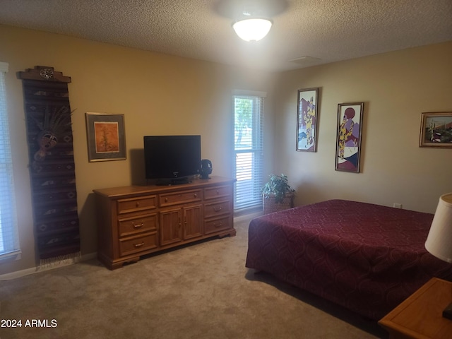 carpeted bedroom with a textured ceiling