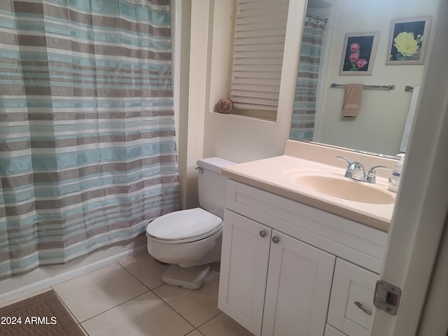 full bathroom featuring shower / bath combo with shower curtain, tile patterned flooring, vanity, and toilet