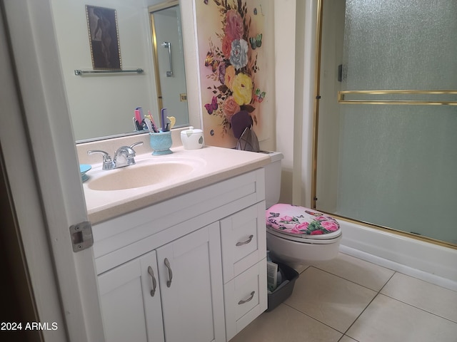 bathroom with toilet, vanity, tile patterned floors, and walk in shower