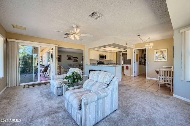 carpeted living room with ceiling fan with notable chandelier and a textured ceiling