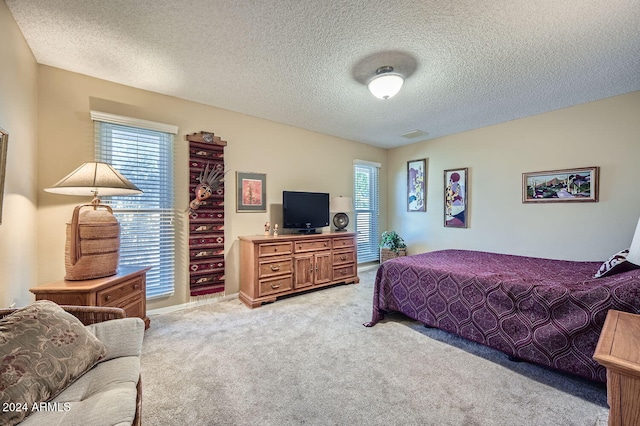 carpeted bedroom featuring a textured ceiling