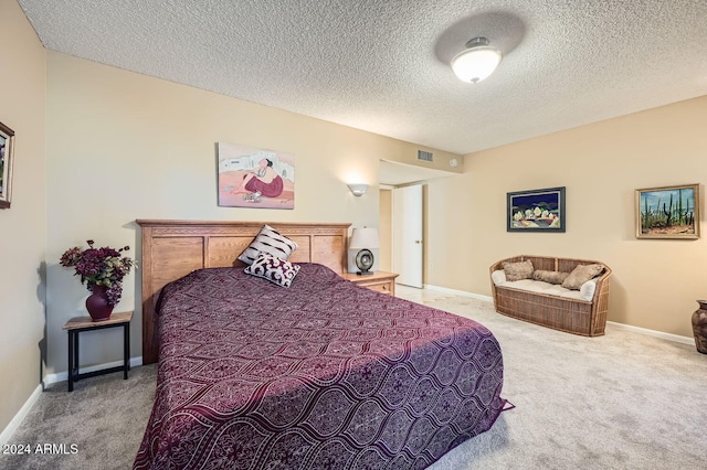 carpeted bedroom featuring a textured ceiling