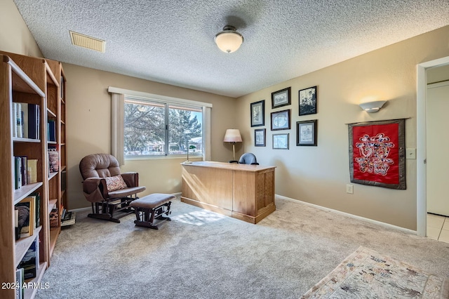 home office with a textured ceiling and light carpet