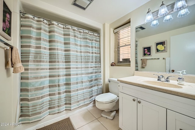 bathroom featuring tile patterned flooring, vanity, and toilet