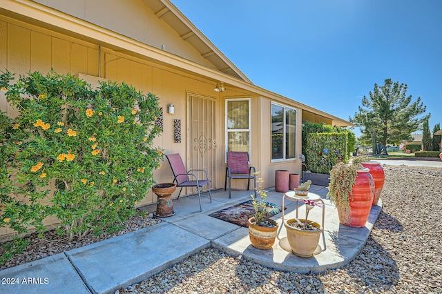 view of exterior entry featuring a patio area