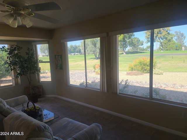 sunroom featuring ceiling fan