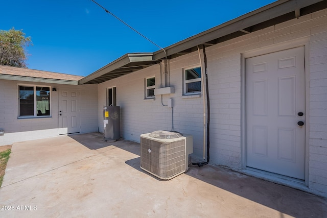 1466 E Nielson Ave, Mesa, AZ 85204 - doorway to property featuring water heater, a patio, and brick siding
