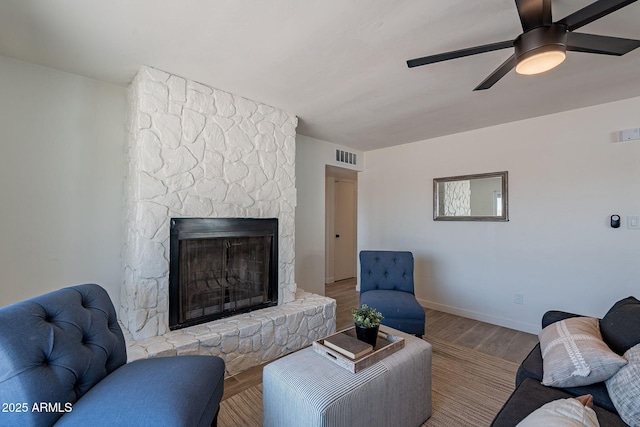 1466 E Nielson Ave, Mesa, AZ 85204 - living area featuring a fireplace, wood finished floors, and ceiling fan