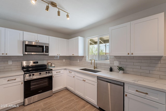 1466 E Nielson Ave, Mesa, AZ 85204 - kitchen featuring appliances with stainless steel finishes, white cabinets, backsplash, light wood-type flooring, and light stone countertops
