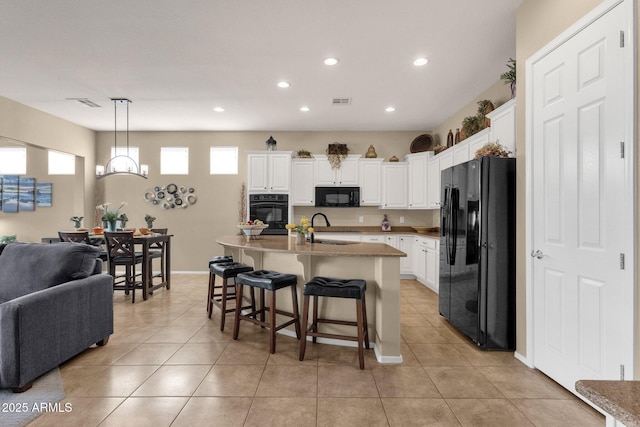 4293 E Sourwood Dr, Gilbert, AZ 85298 - kitchen with black appliances, open floor plan, a sink, recessed lighting, and a breakfast bar area