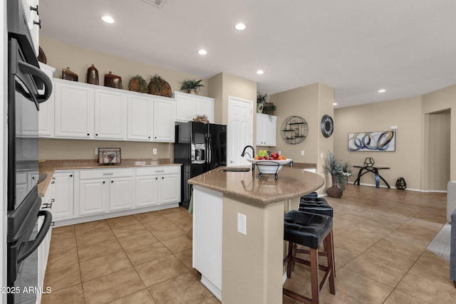 4293 E Sourwood Dr, Gilbert, AZ 85298 - kitchen featuring black appliances, a sink, a kitchen breakfast bar, recessed lighting, and light tile patterned flooring