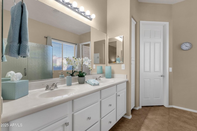 4293 E Sourwood Dr, Gilbert, AZ 85298 - bathroom featuring tile patterned flooring, double vanity, and baseboards
