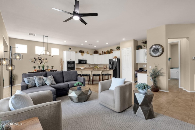 4293 E Sourwood Dr, Gilbert, AZ 85298 - living room with a ceiling fan, light tile patterned flooring, a chandelier, baseboards, and recessed lighting