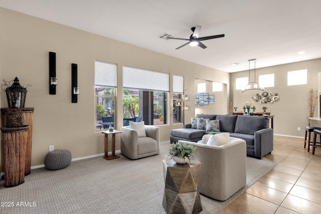 4293 E Sourwood Dr, Gilbert, AZ 85298 - living room with a ceiling fan, a chandelier, baseboards, and light tile patterned floors