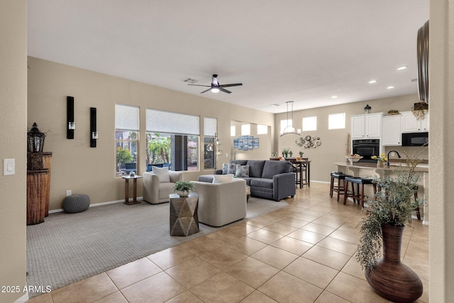 4293 E Sourwood Dr, Gilbert, AZ 85298 - living area with ceiling fan, light tile patterned flooring, recessed lighting, light carpet, and baseboards