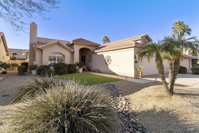 mediterranean / spanish house with a garage