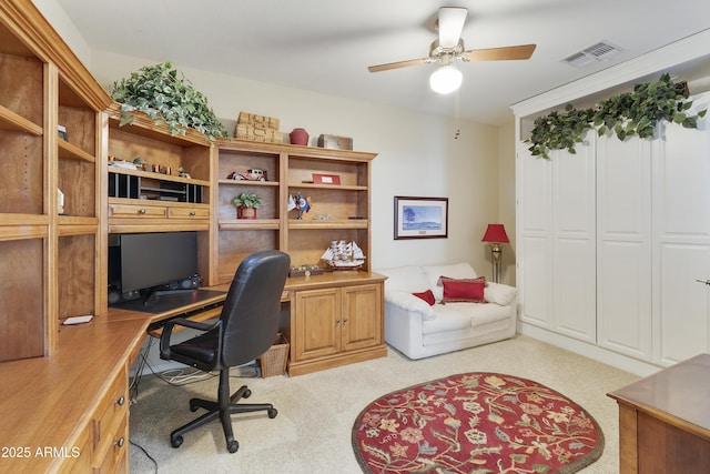 carpeted home office with ceiling fan