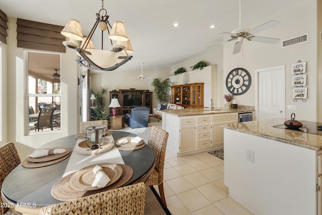 dining space featuring sink, beverage cooler, and light tile patterned floors