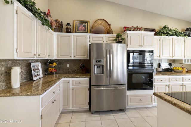 kitchen featuring black appliances, white cabinetry, and vaulted ceiling