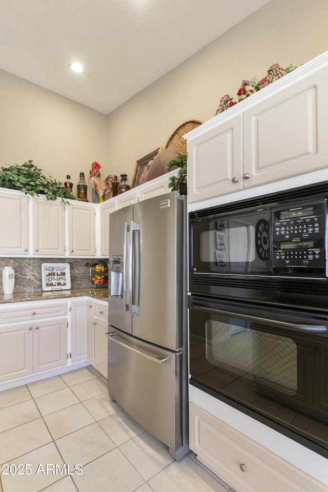 kitchen with white cabinets, black oven, tasteful backsplash, light tile patterned floors, and stainless steel fridge with ice dispenser