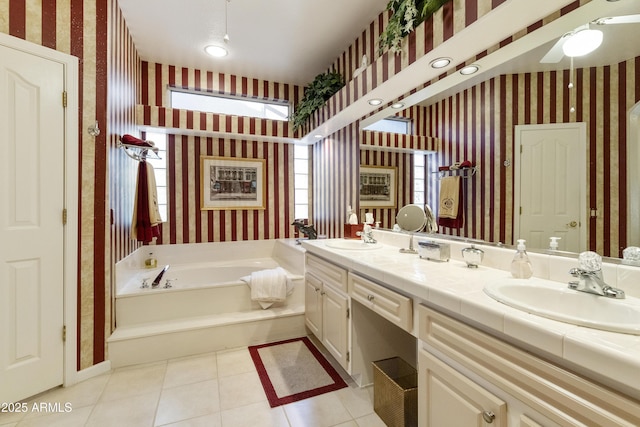 bathroom featuring vanity, tile patterned flooring, ceiling fan, and a tub