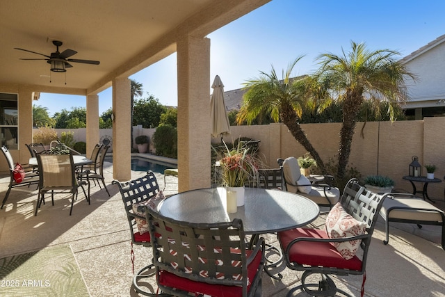 view of patio with ceiling fan and a fenced in pool