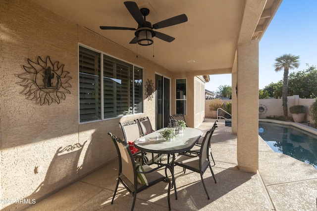 view of patio / terrace with ceiling fan and a fenced in pool