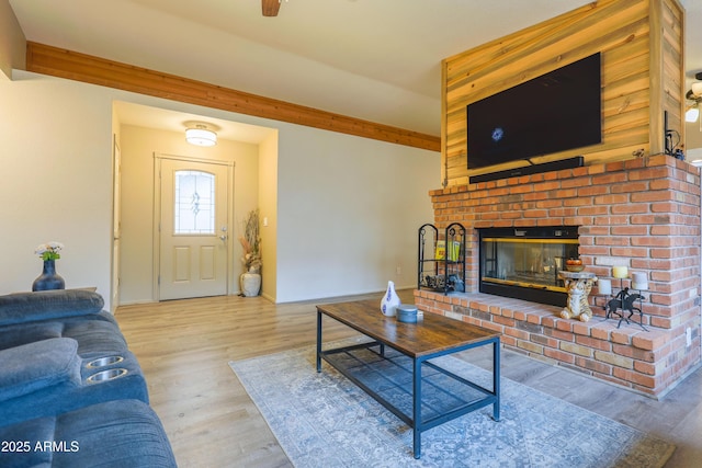 living room with a fireplace and light hardwood / wood-style flooring