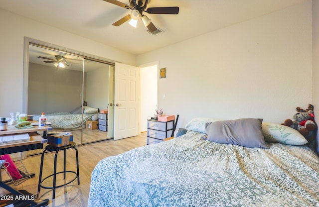 bedroom featuring ceiling fan, light hardwood / wood-style floors, and a closet