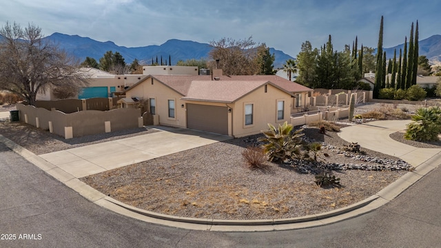 view of front of house featuring a mountain view and a garage