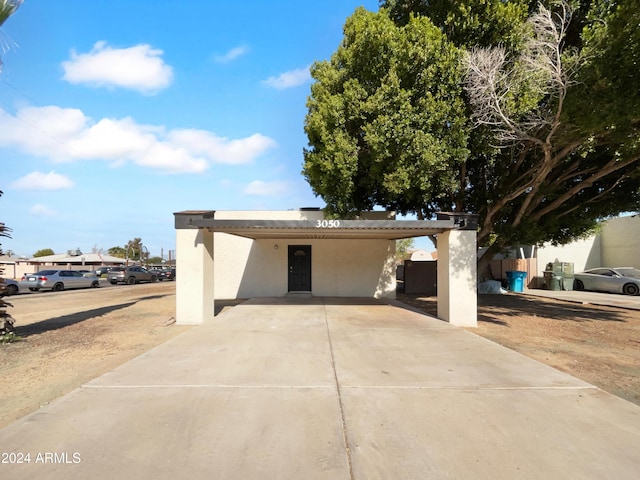 view of front of property featuring a carport