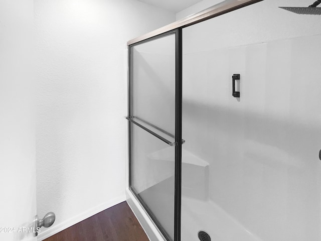 bathroom featuring hardwood / wood-style floors and an enclosed shower