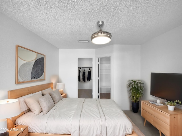 carpeted bedroom featuring a textured ceiling