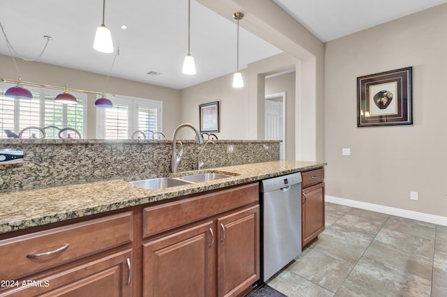 kitchen featuring dishwasher, light stone countertops, sink, and hanging light fixtures