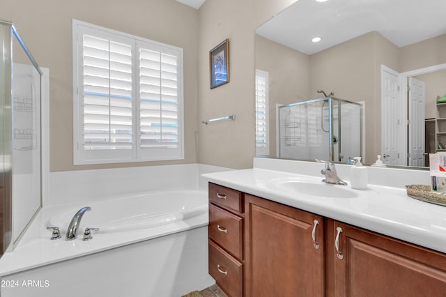 bathroom featuring vanity and shower with separate bathtub