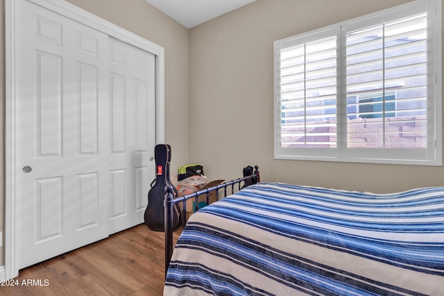 bedroom with hardwood / wood-style floors and a closet