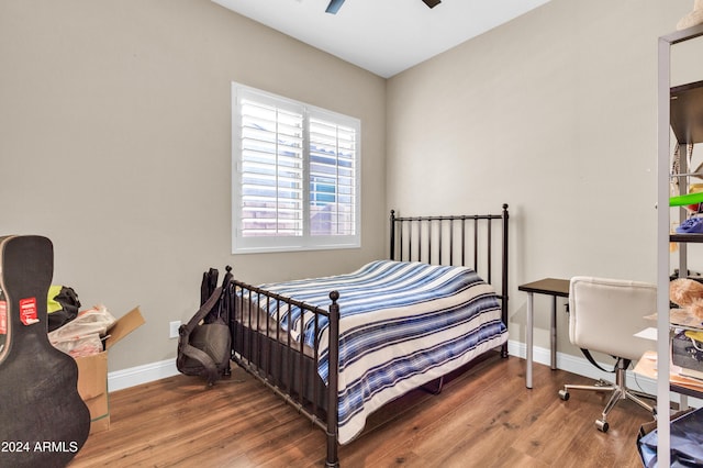 bedroom with ceiling fan and wood-type flooring