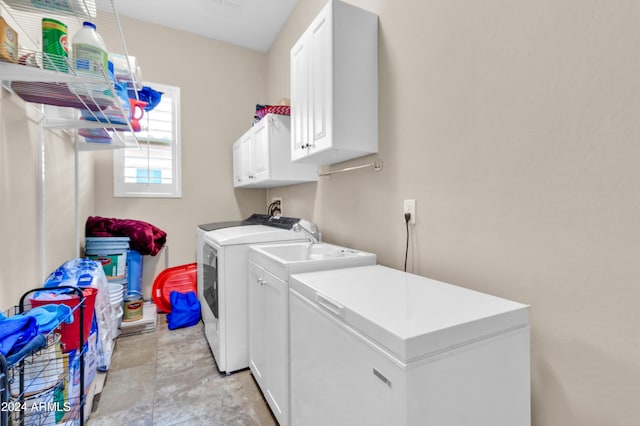 laundry room with cabinets and washing machine and dryer