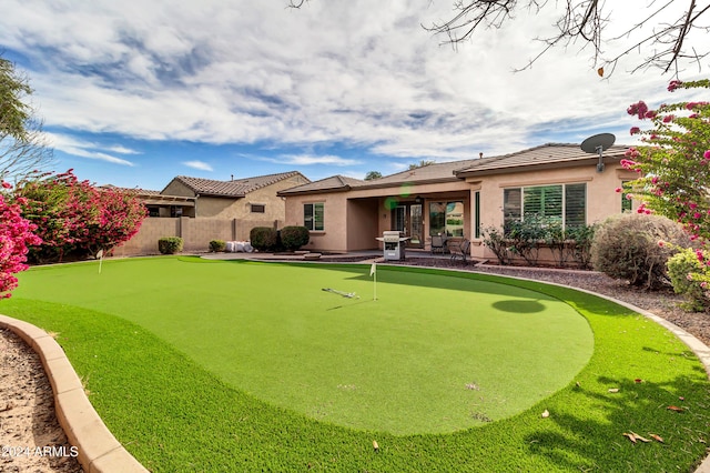 back of property with a patio