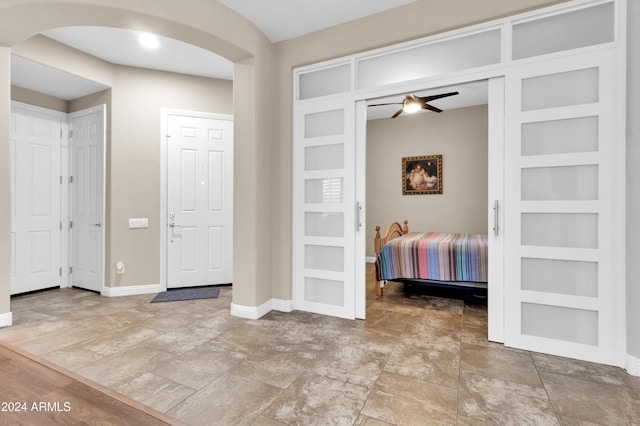 entrance foyer with ceiling fan