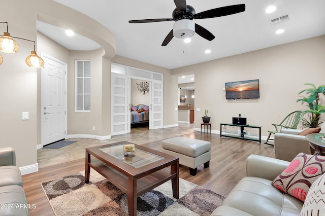 living room featuring ceiling fan and light wood-type flooring