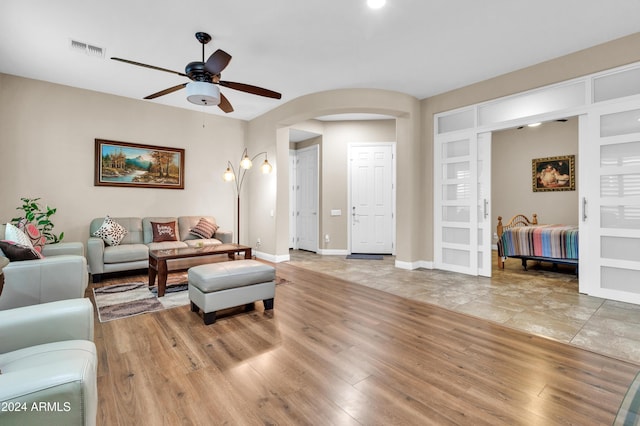 living room featuring ceiling fan and light hardwood / wood-style floors