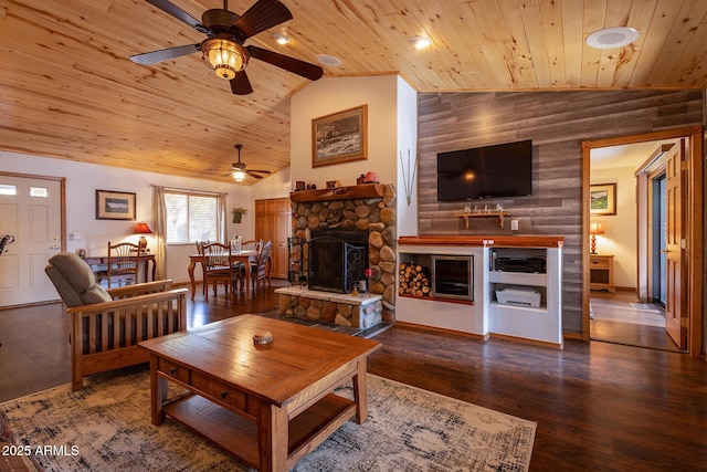 living room with wood ceiling, wood-type flooring, vaulted ceiling, and a stone fireplace