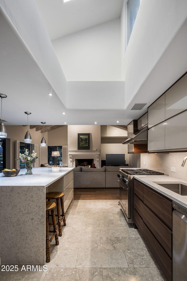 8312 N Golf Dr, Paradise Valley, AZ 85253 - kitchen with a sink, light countertops, stainless steel appliances, a kitchen bar, and modern cabinets